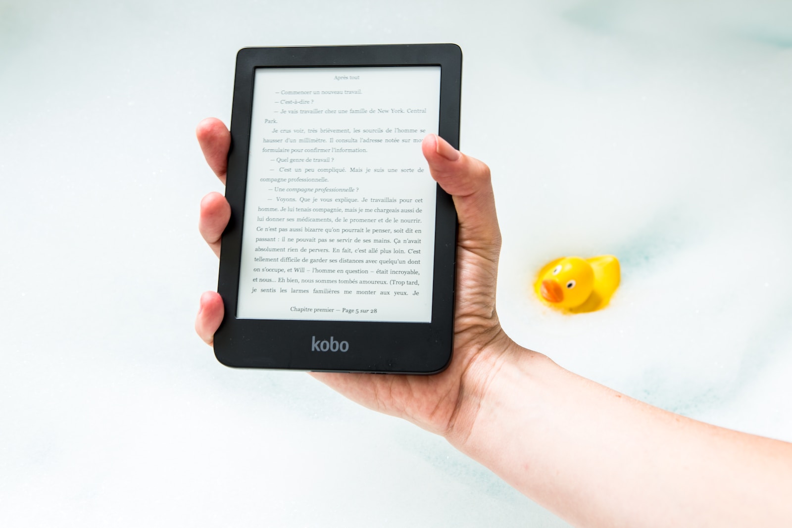 person holding turned on Amazon Kindle ebook reader